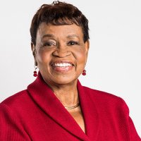 Headshot of Catherine Alicia Georges, EdD, RN, FAAN in a red jacket